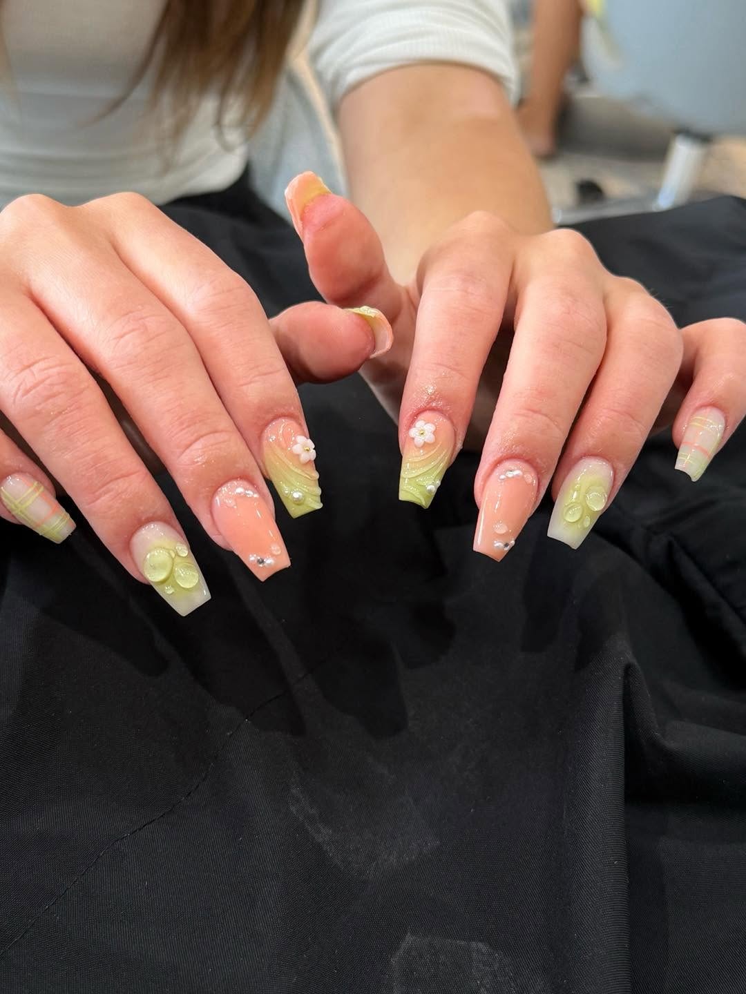 Green and peach nail art with 3D floral and rhinestone details by Beauty Genesis
